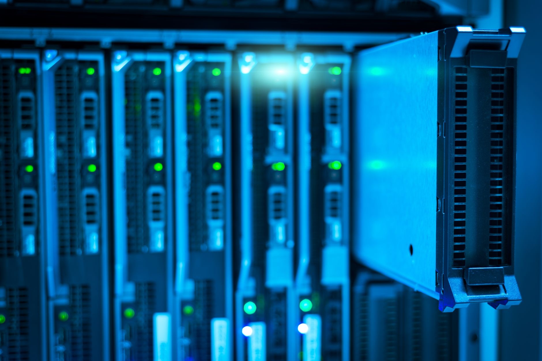Rows of illuminated servers inside a large data center facility