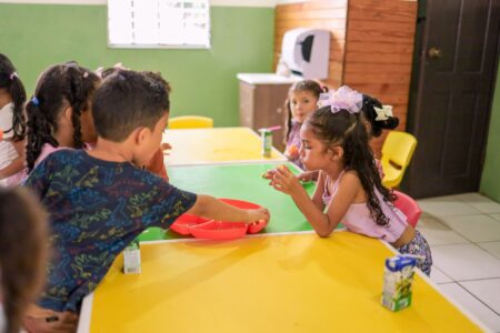 Young children playing inside a licensed daycare center classroom
