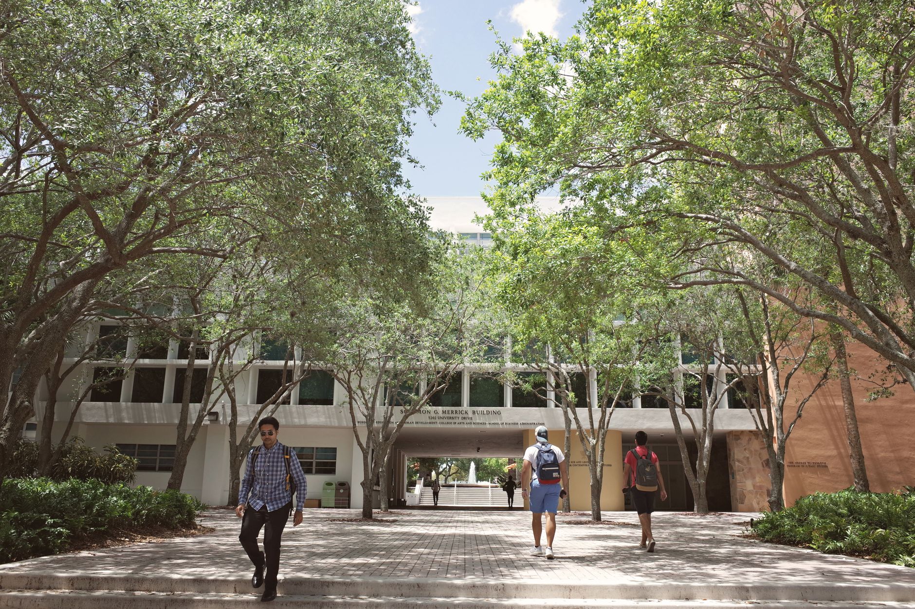 Students walking across a college campus, representing the population Pell Grants are designed to support