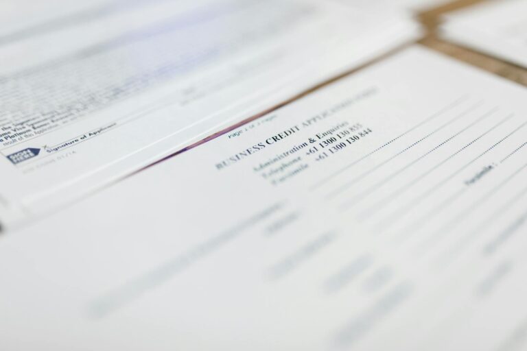 Person reviewing health insurance enrollment paperwork at a desk