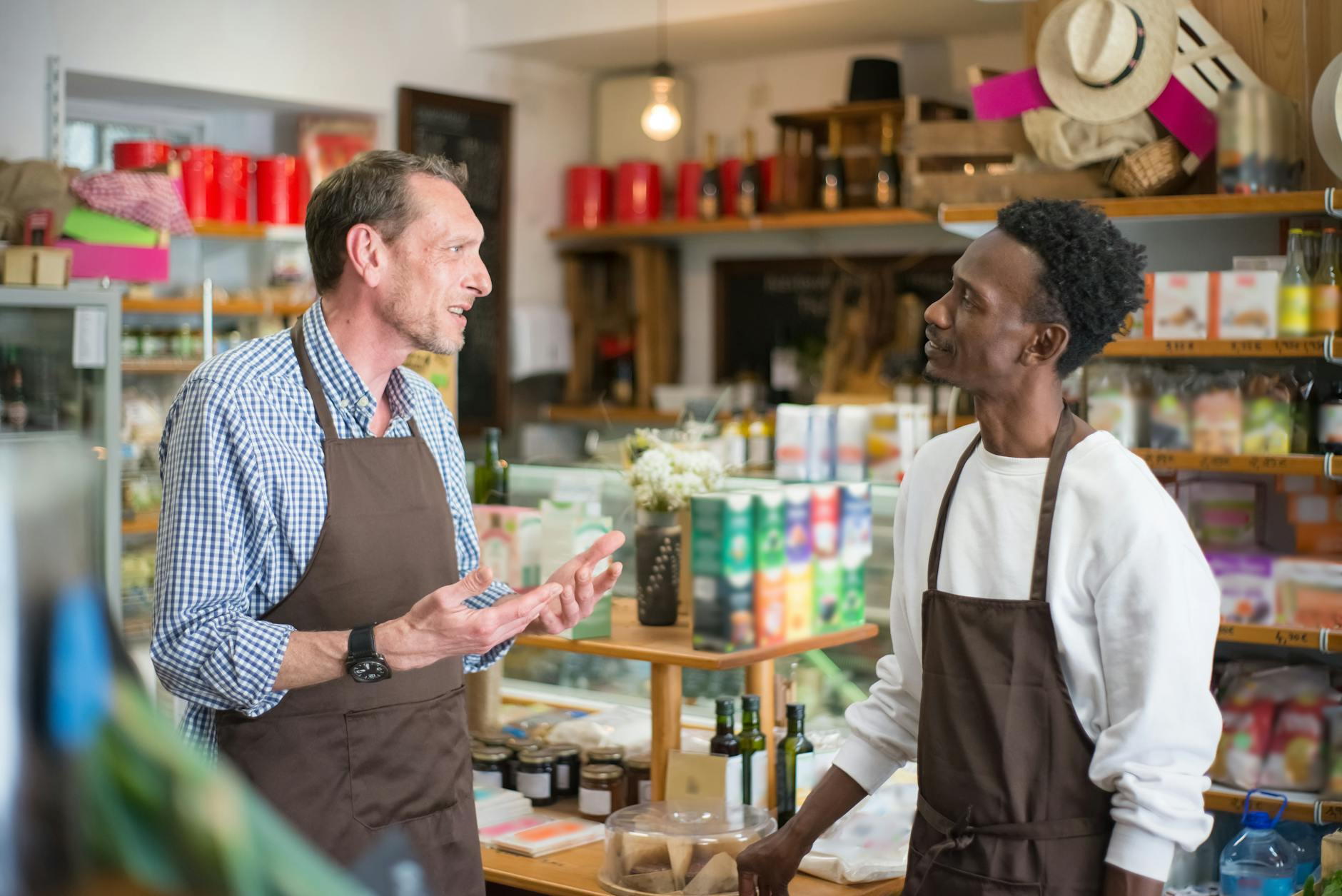 A retail employee assisting a customer at a store checkout area