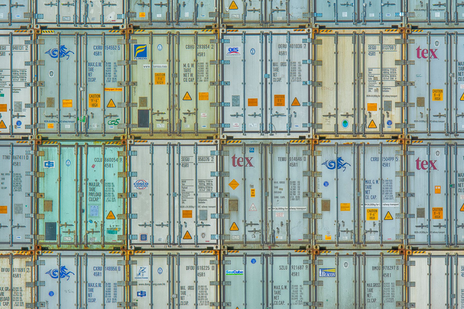 Rows of colorful shipping containers stacked at an intermodal freight terminal