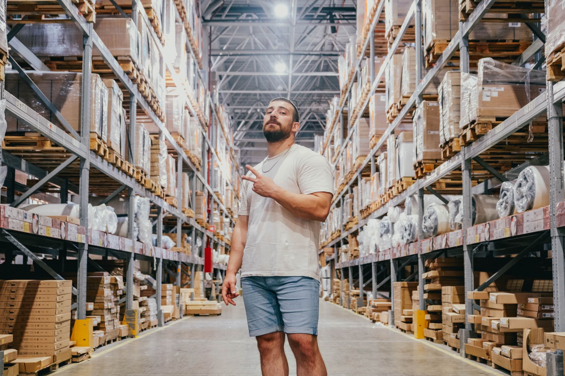Rows of apparel merchandise stored inside a large retail distribution warehouse