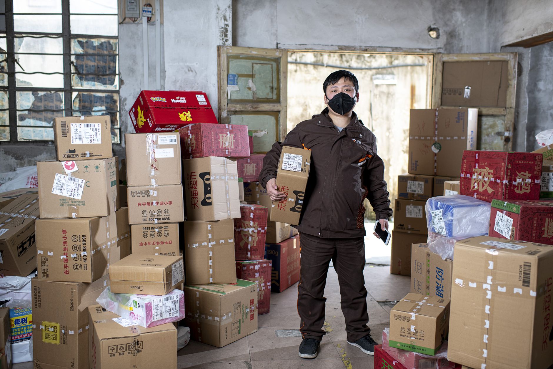 Workers sorting packages at a postal distribution facility