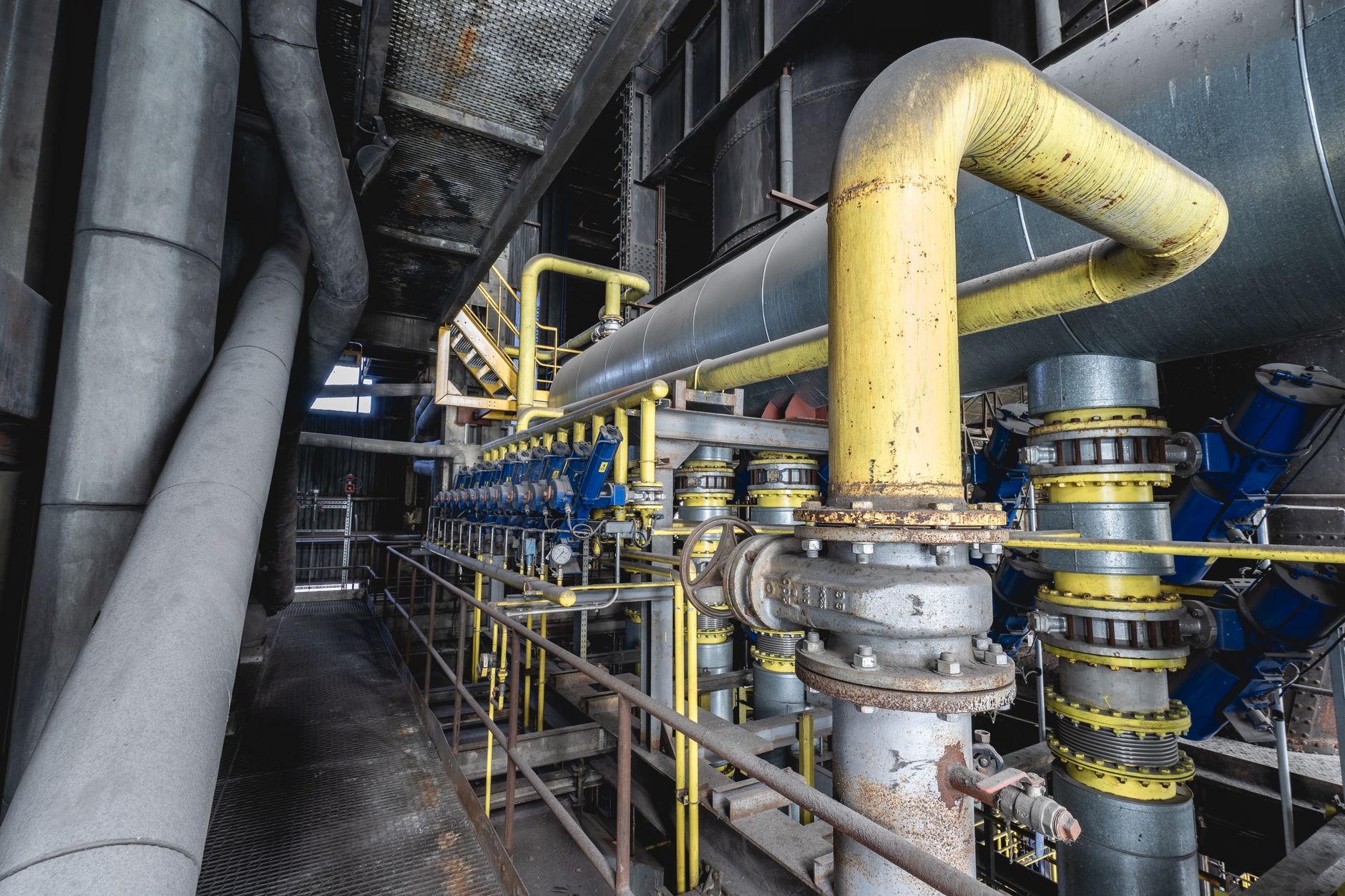 Large industrial equipment sitting unused inside a manufacturing plant