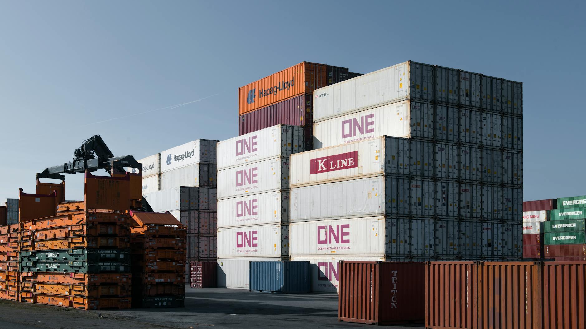Rows of colorful shipping containers at an industrial freight yard