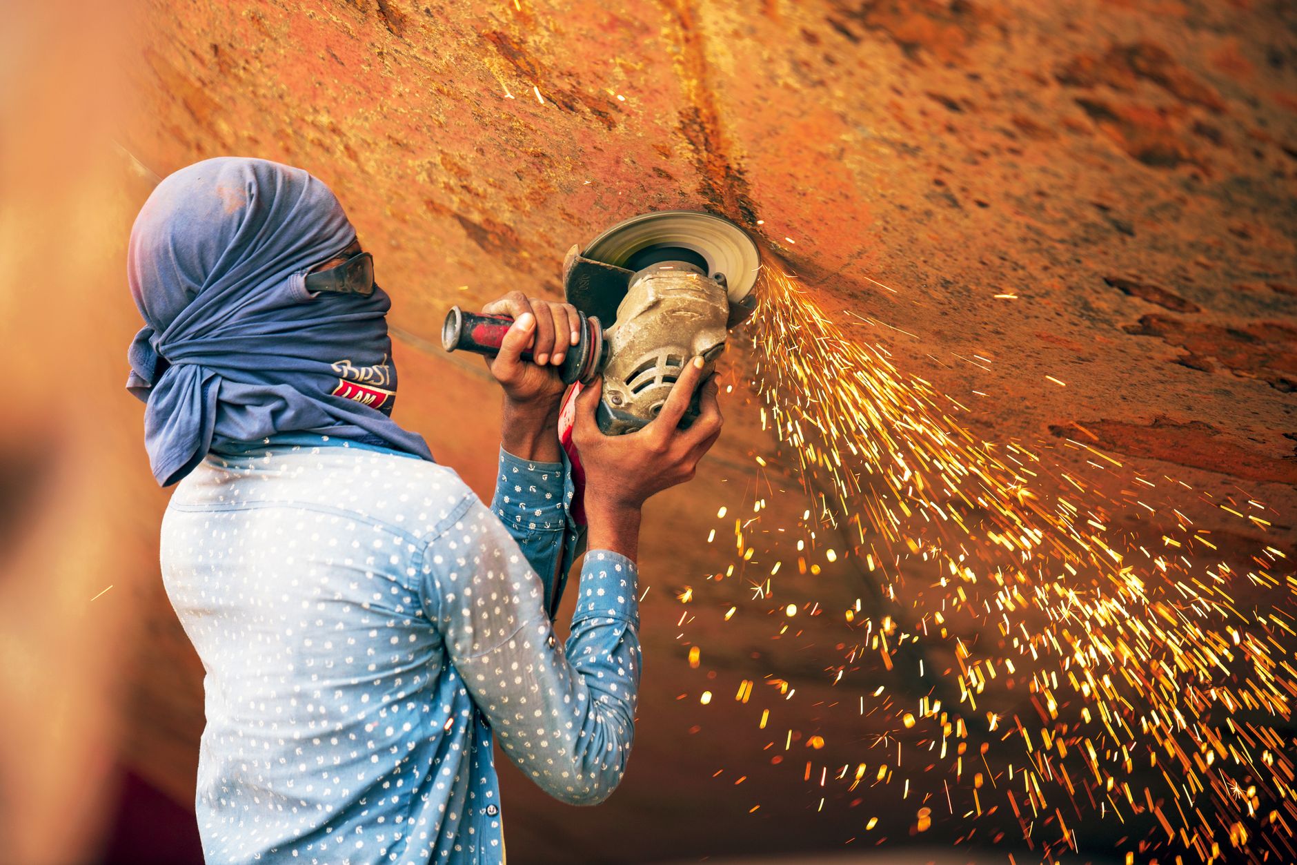 A migrant worker looking at a phone in an urban setting
