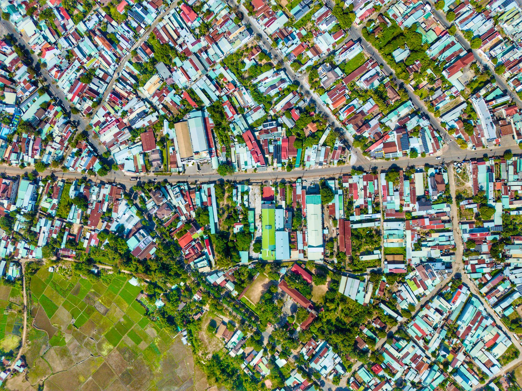 Aerial view of a mid-tier American suburb with rows of houses and commercial streets