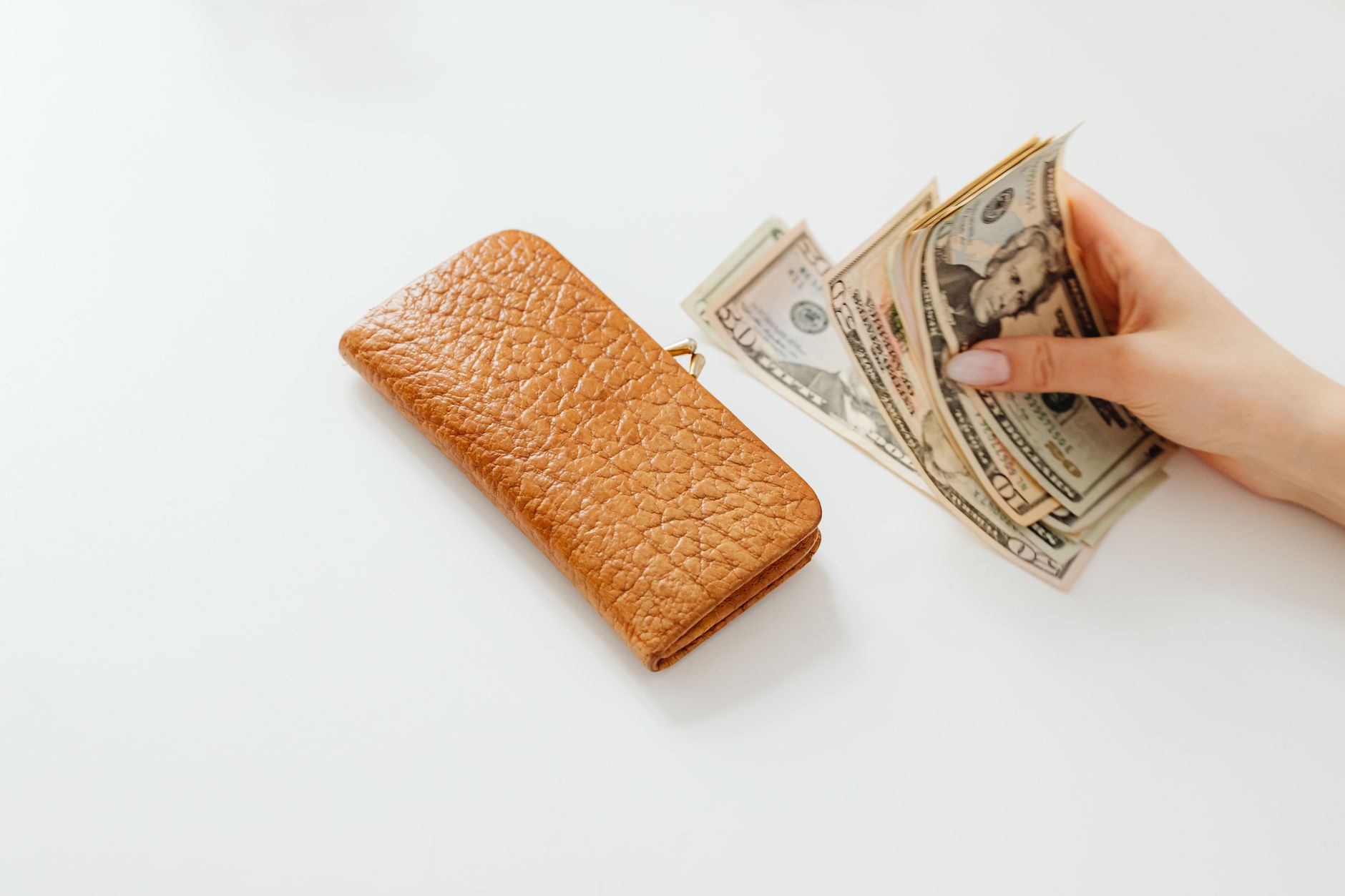Wallet with cash and cards representing household costs affected by credit card fee rules
