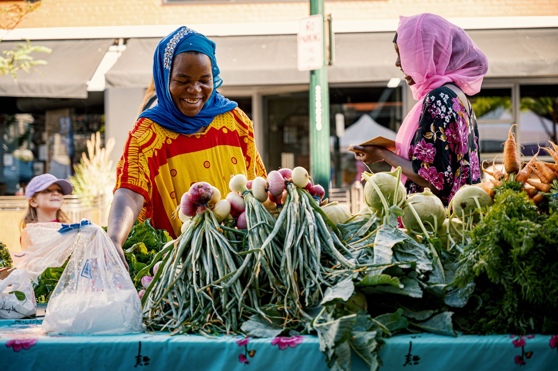 Fresh eggs and produce for sale at an outdoor farmers market