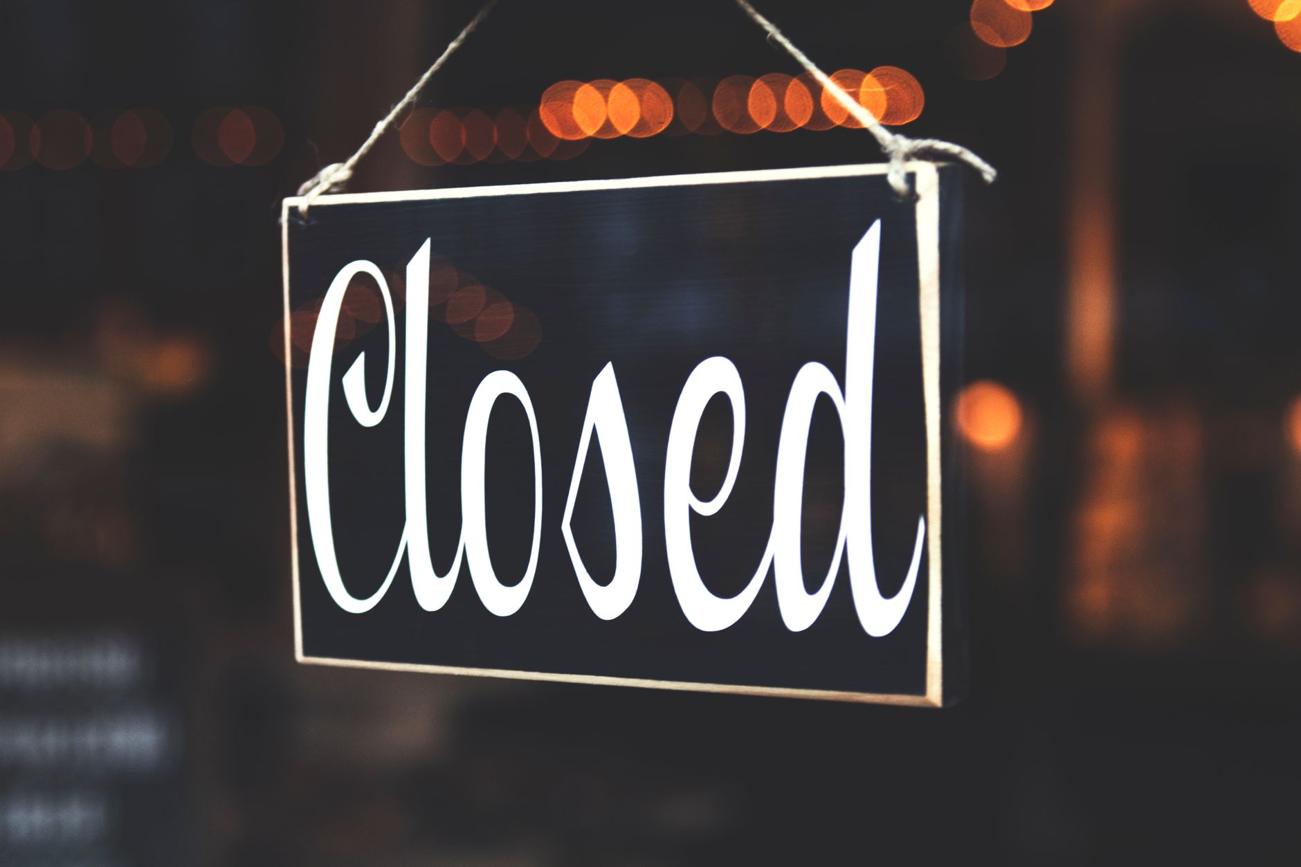 Closed sign on the door of a small business storefront