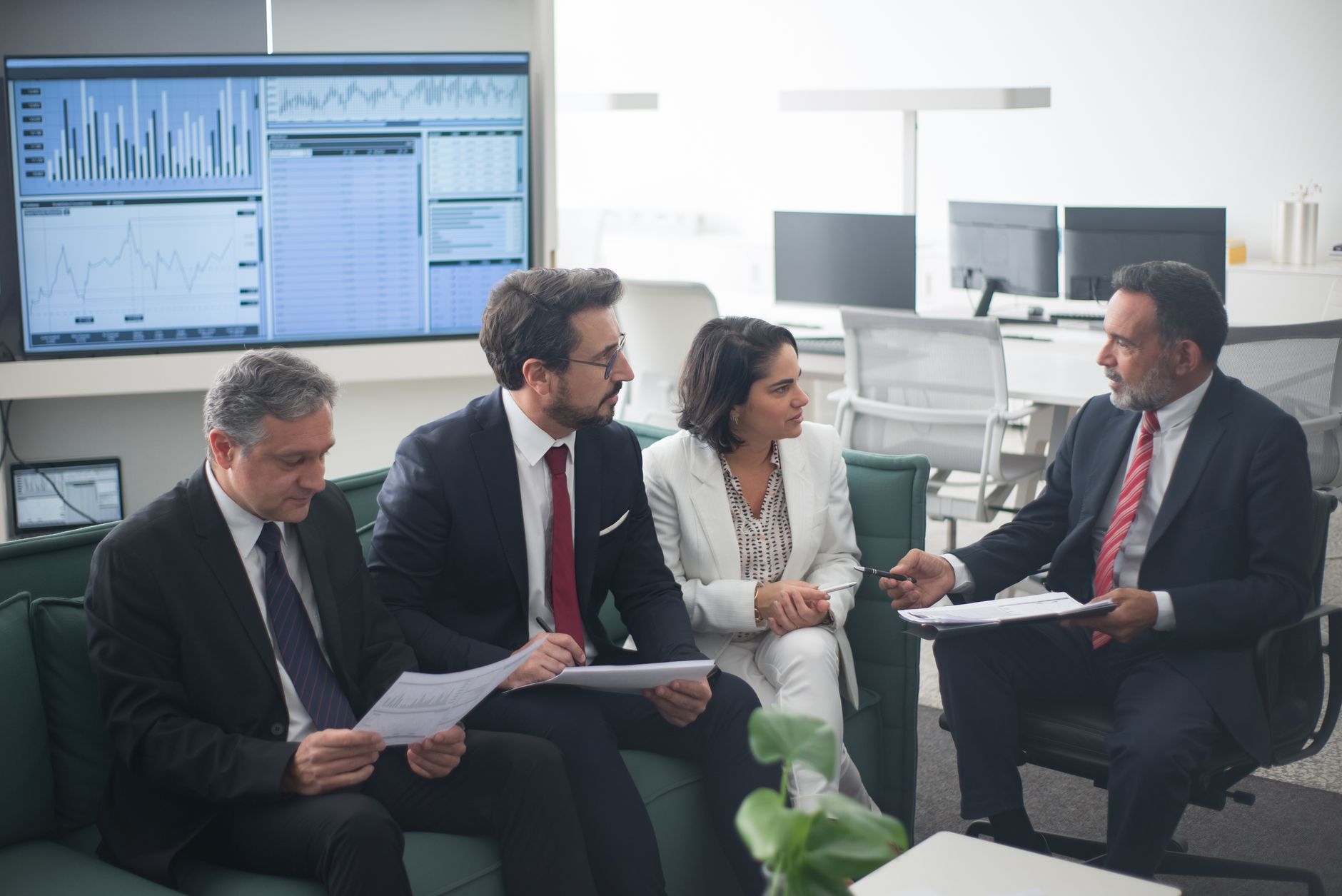 Two people reviewing financial documents at a desk representing wealth management planning