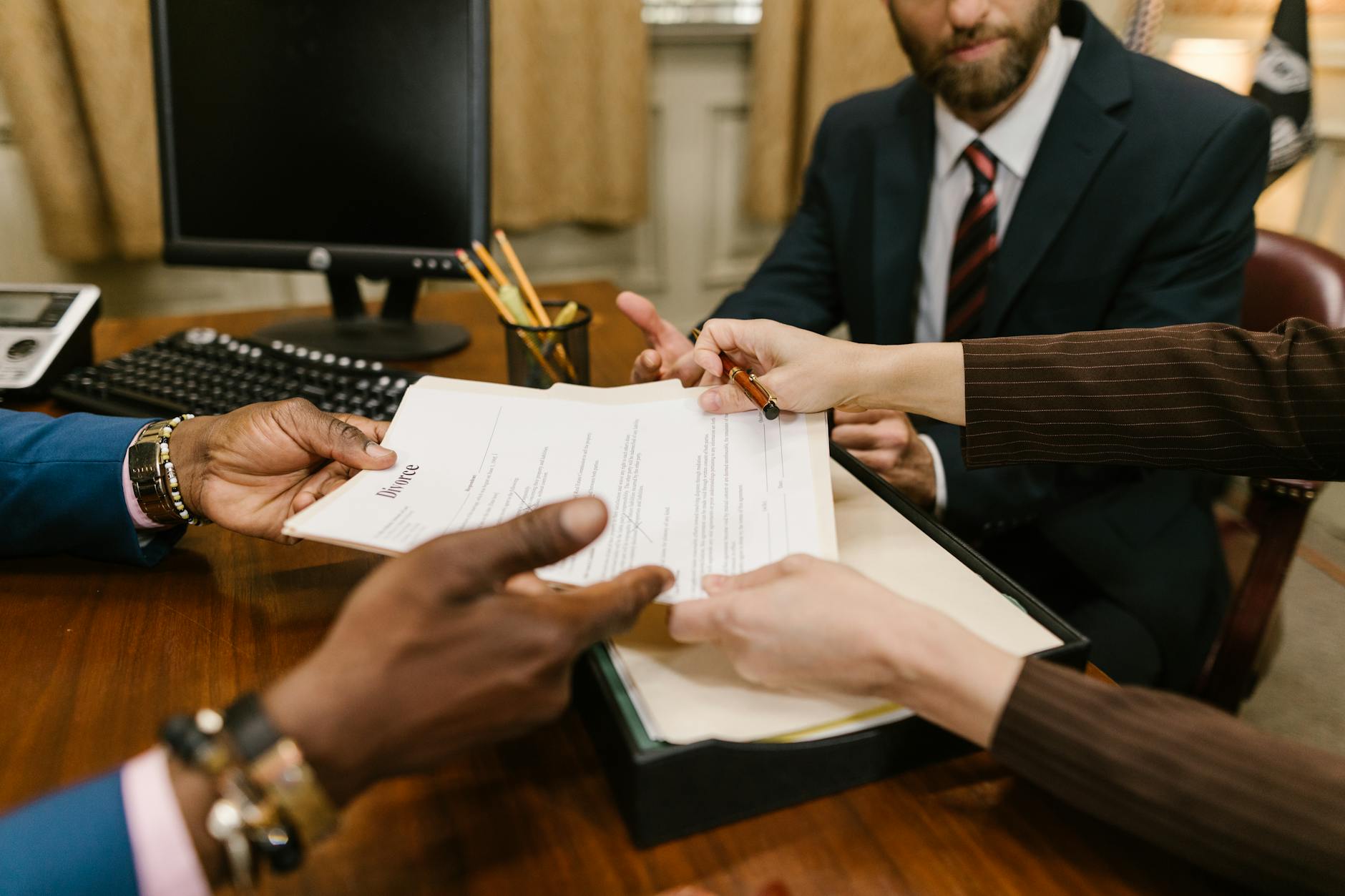 Two sides seated at a table in a formal contract negotiation setting