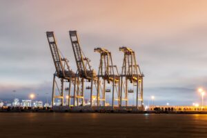 Large container port cranes unloading cargo ships at a busy terminal
