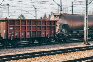 Freight train moving along industrial rail tracks representing the railroad industry workforce