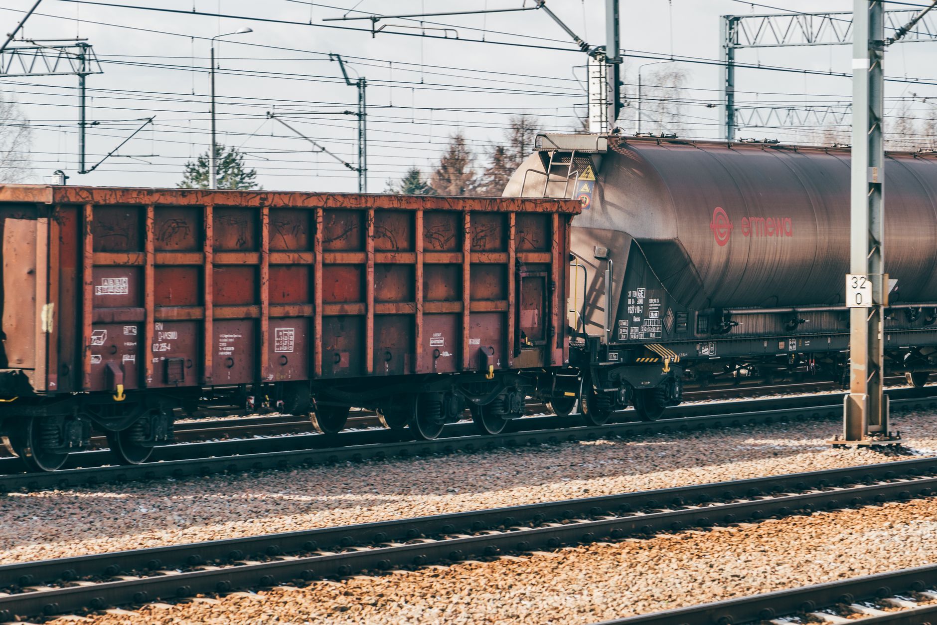 Freight train moving along industrial rail tracks representing the railroad industry workforce