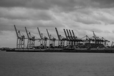 Large automated cranes operating at a commercial shipping port terminal