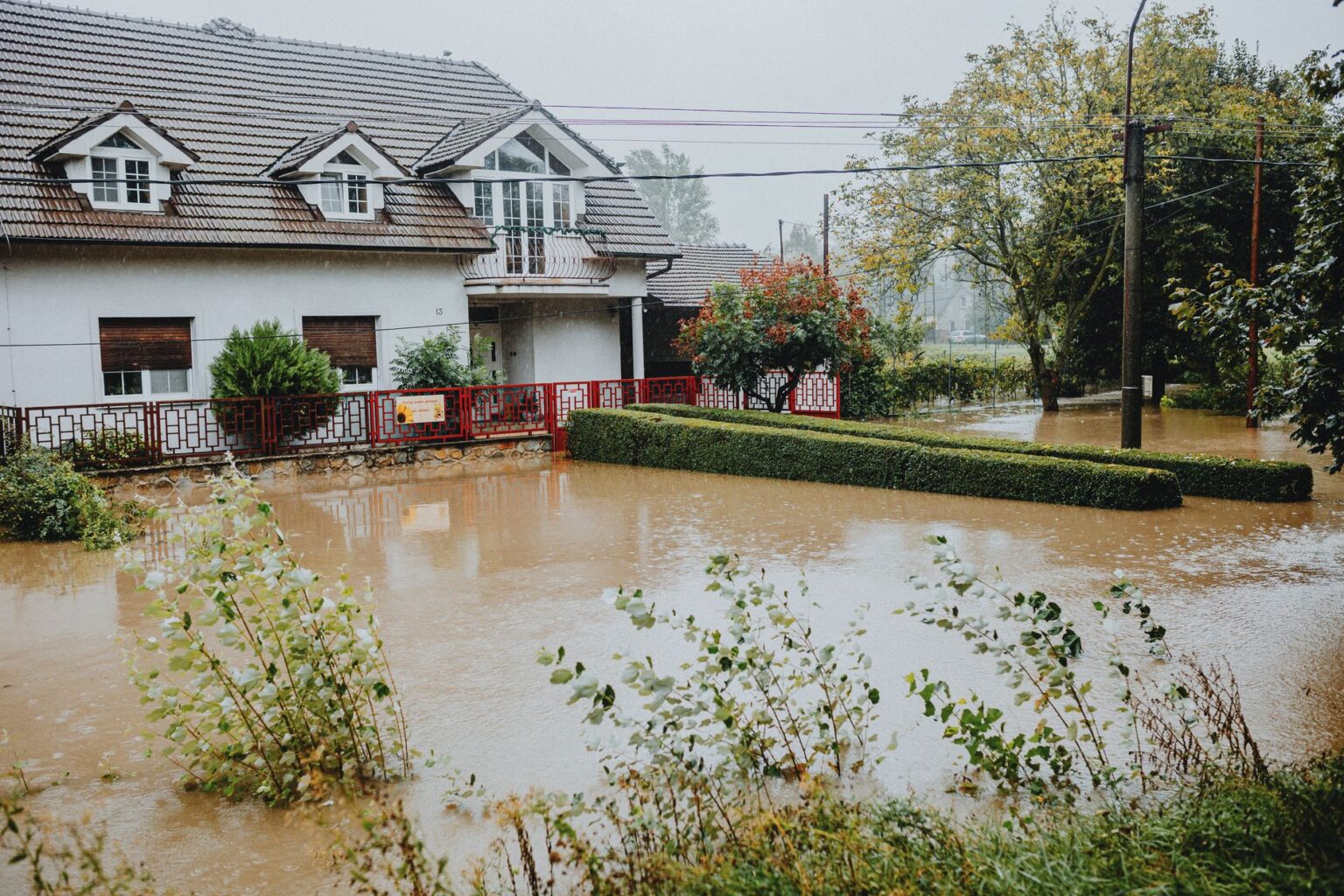 FEMA Flood Map Delays Leave Insurers and Homeowners in the Dark Flooded residential street with water covering road and driveways