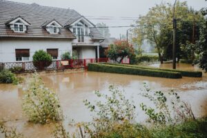 Flooded residential street with water covering road and driveways