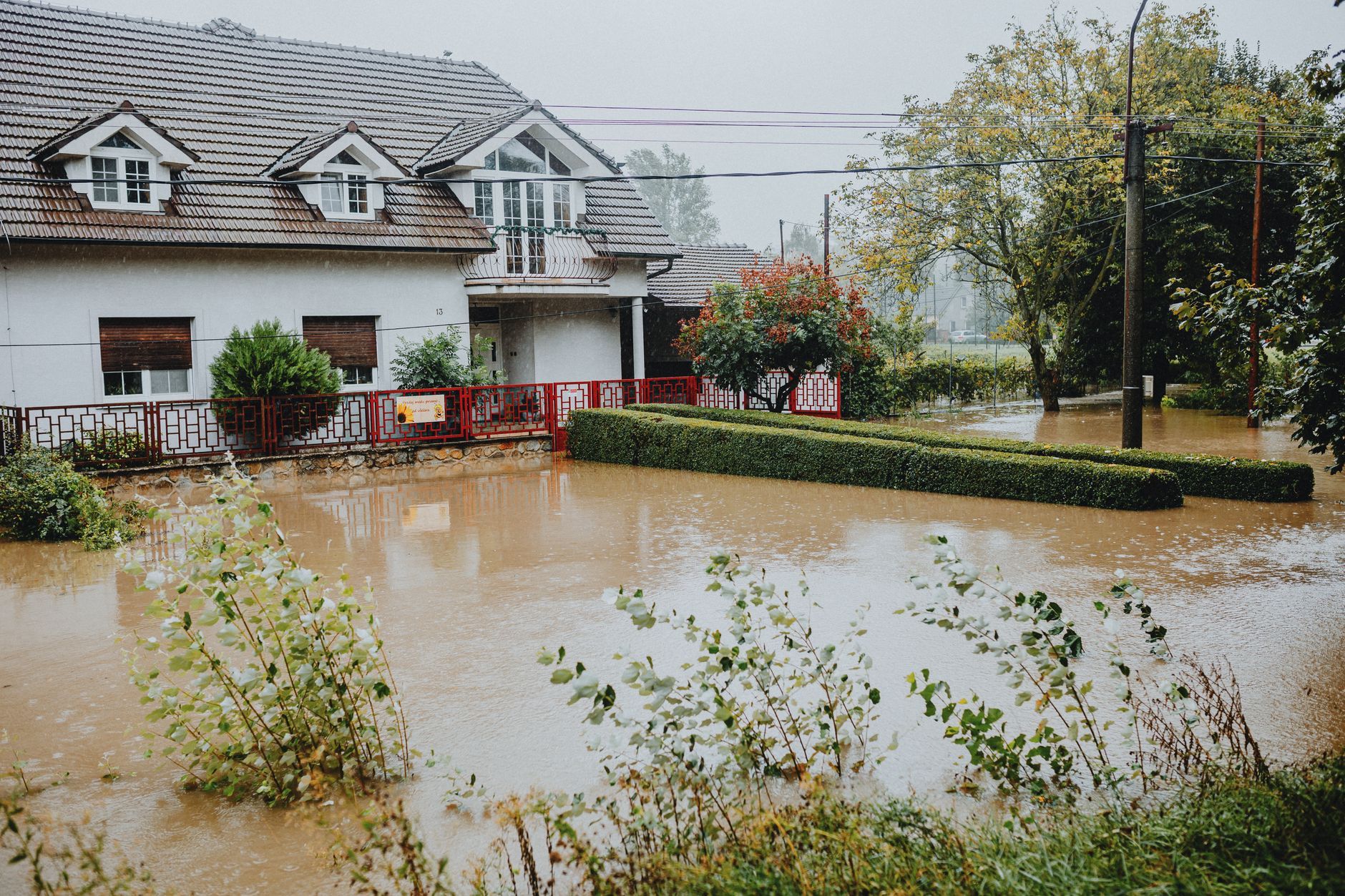 Flooded residential street with water covering road and driveways