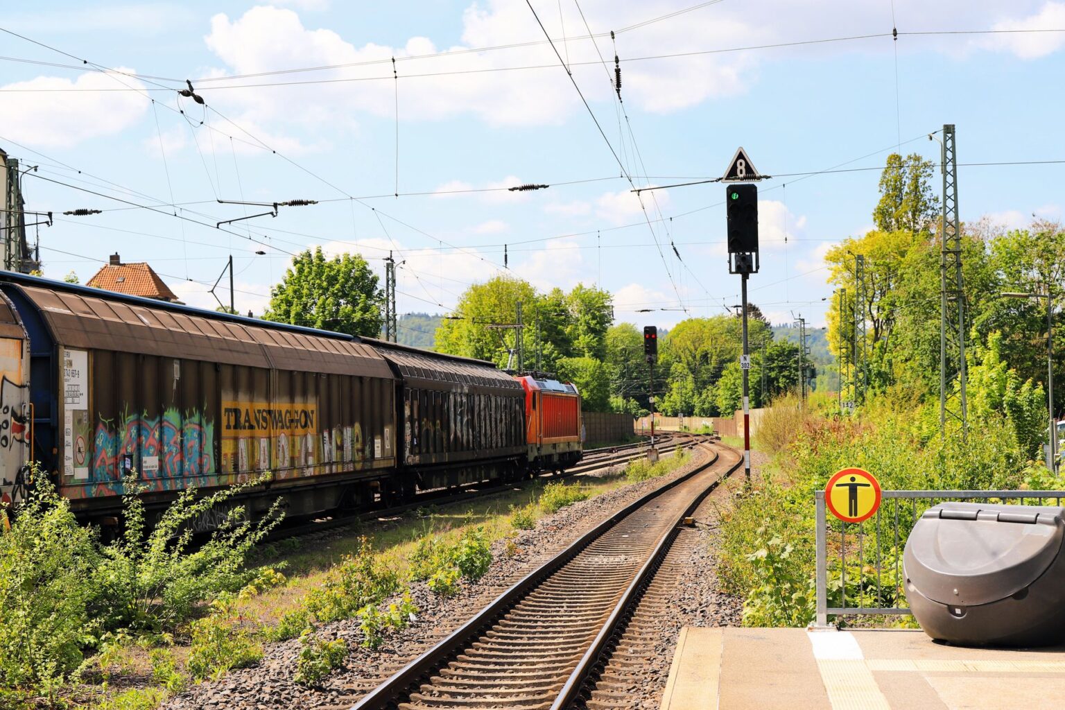 Freight Rail Contract Talks Stall as Shipper Costs Mount A long freight train carrying cargo containers across an open rail corridor