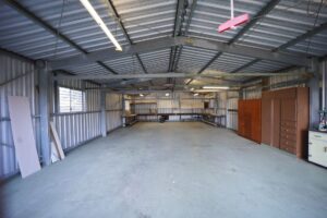 Large warehouse interior with stacked pallets and inventory on shelving systems