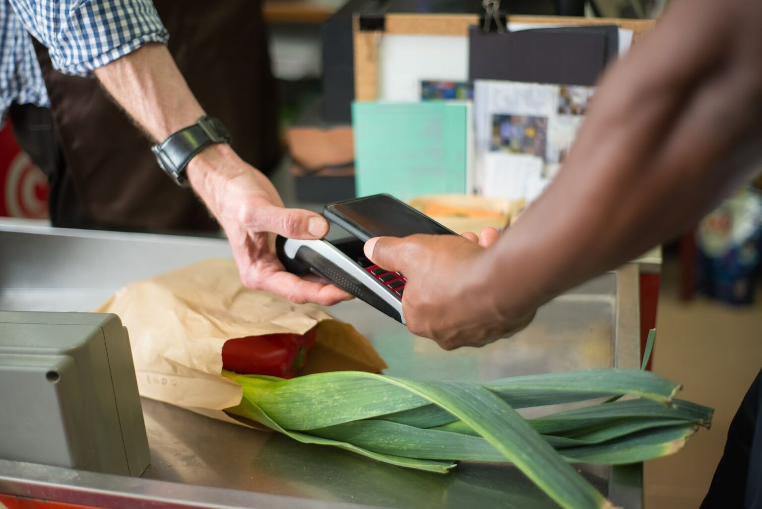 Grocery Store Loyalty Card Data Is Quietly Reshaping Food Policy A shopper swiping a loyalty card at a grocery store checkout counter