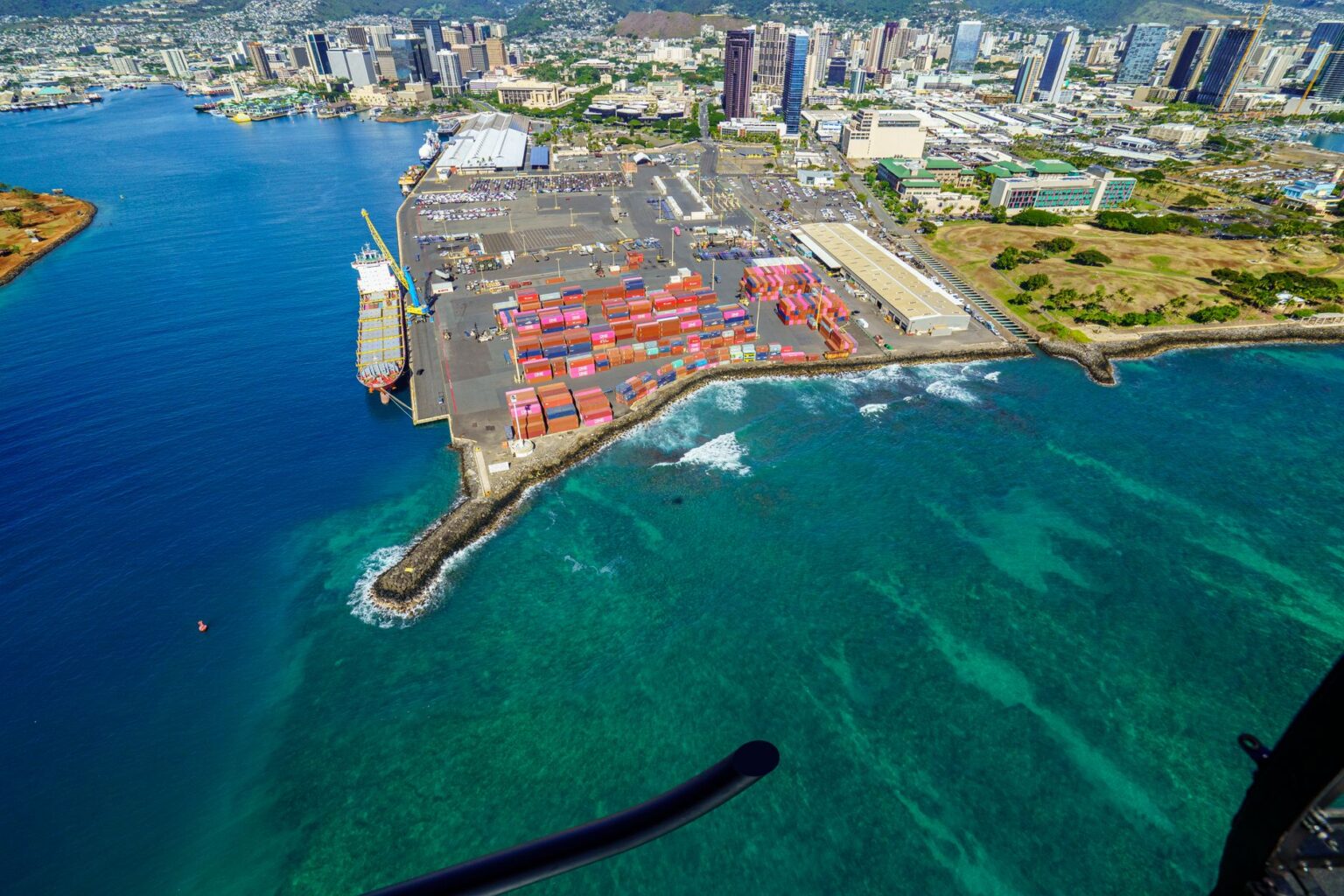 Dock Worker Hiring Freezes Spread as Cargo Volume Shifts Inland Aerial view of a large shipping container port with stacked cargo containers