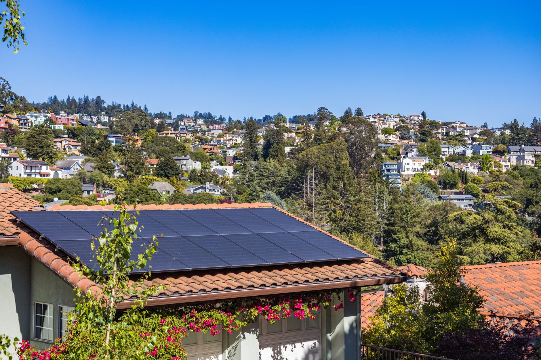 Residential solar panels installed on a suburban rooftop under bright sunlight