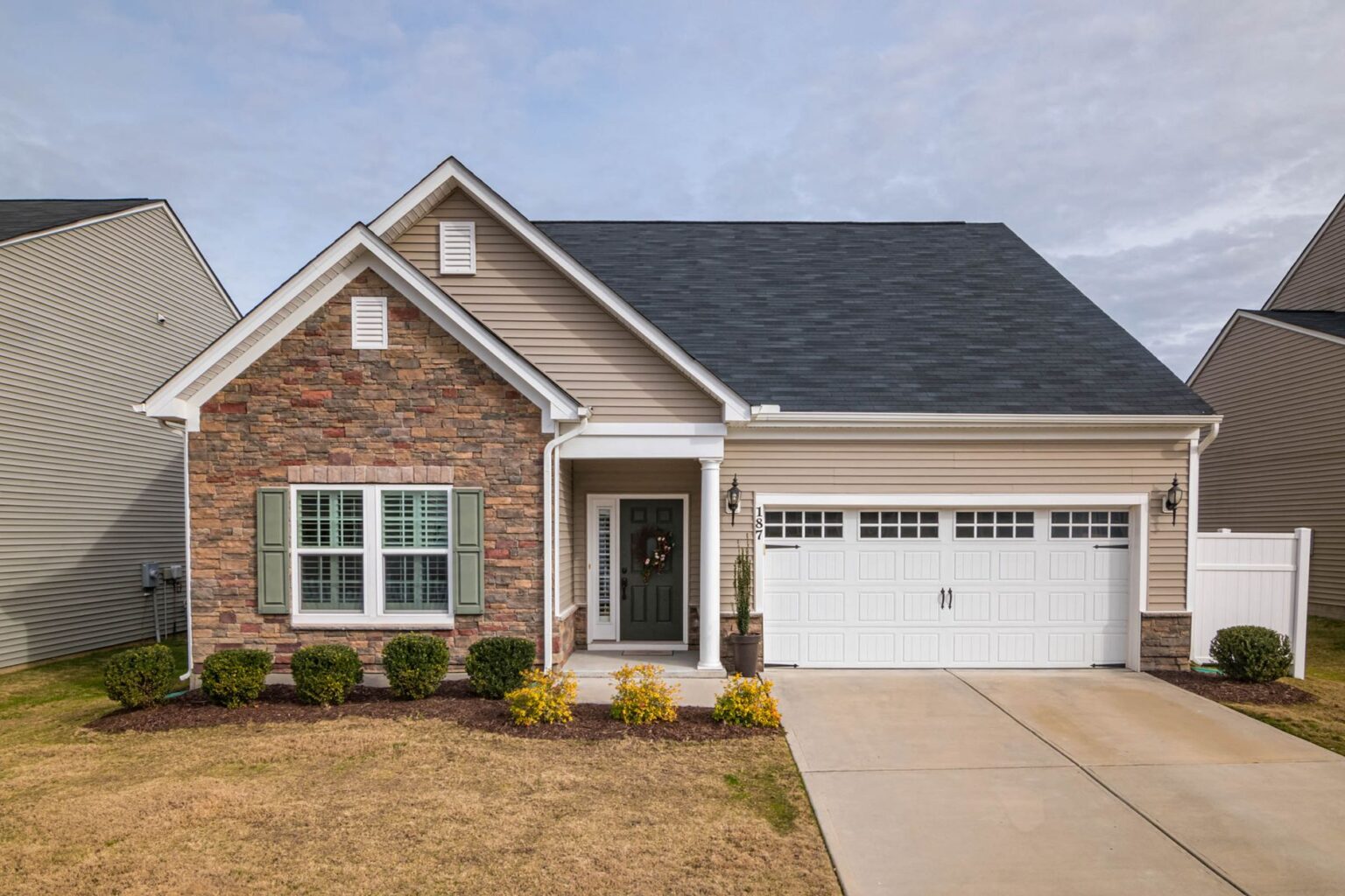 A single-family suburban home with a for-sale sign in the front yard representing the first-time buyer housing market