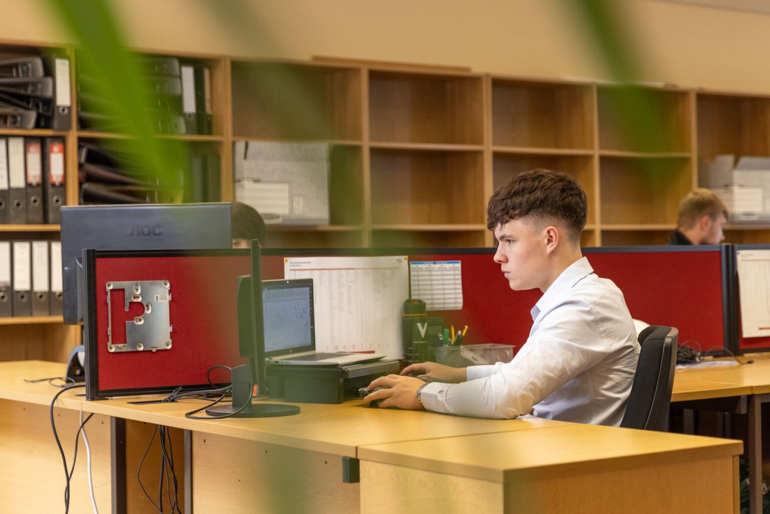 Salaried office worker reviewing documents at a desk, representing workers affected by overtime rule changes