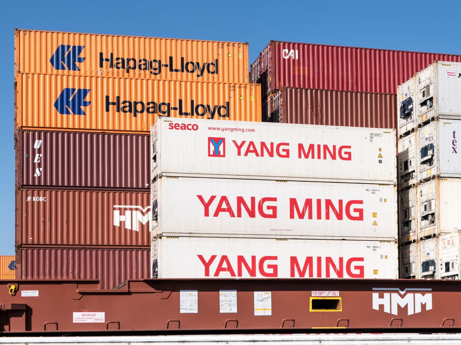 Tariff Whiplash Leaves Small Importers Holding Canceled Orders Rows of shipping containers stacked at a commercial port terminal