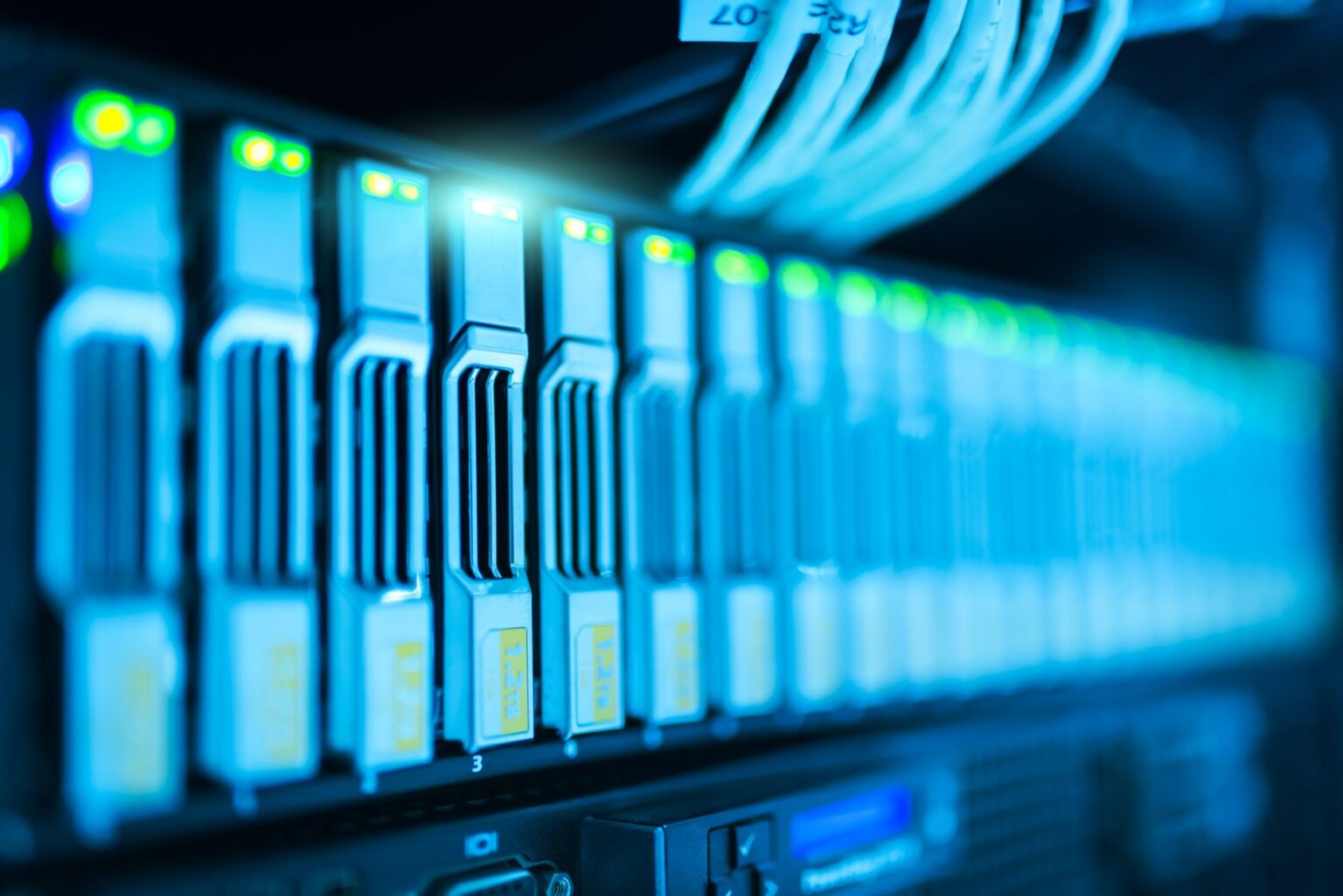 Rows of illuminated server racks inside a large data center facility