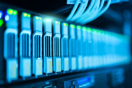 Rows of illuminated server racks inside a large data center facility