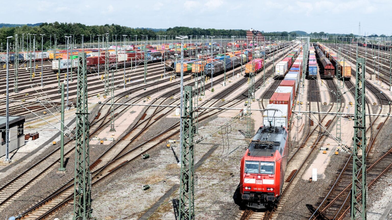 Freight Rail Volume Slump Deepens as Manufacturing Orders Cool A freight train moving along rail tracks through an industrial corridor