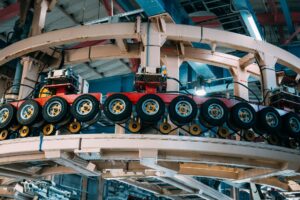 Tariff Uncertainty Freezes Capital Spending Plans at Mid-Size Manufacturers Workers on a manufacturing floor surrounded by industrial machinery and production equipment