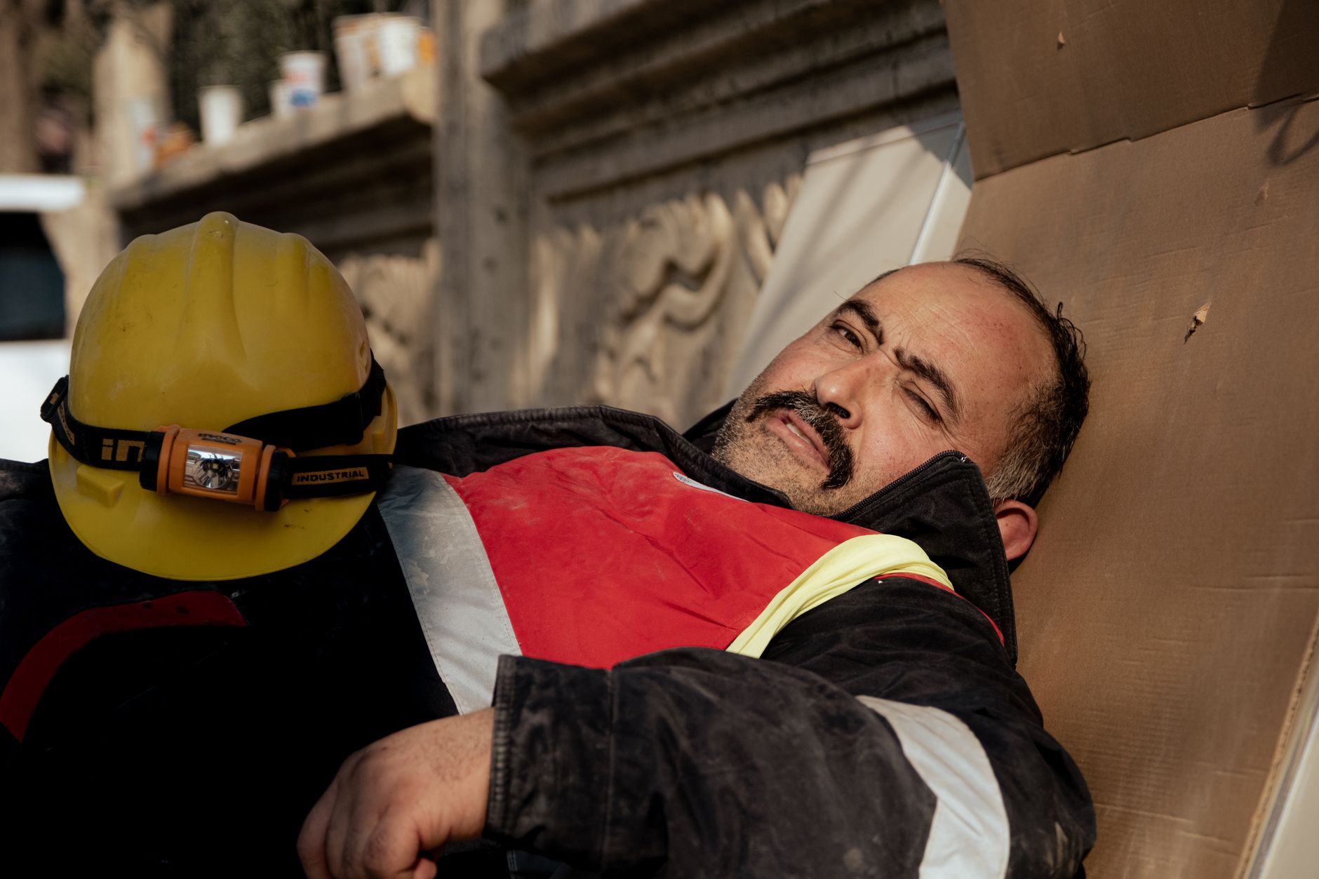 An older male worker looking exhausted at a job site