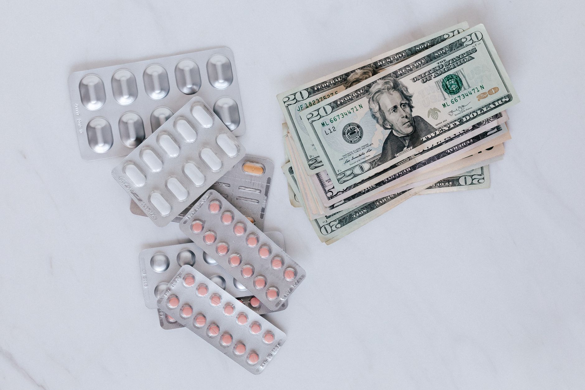 Stack of medical bills on a desk illustrating healthcare cost burden on low-income patients