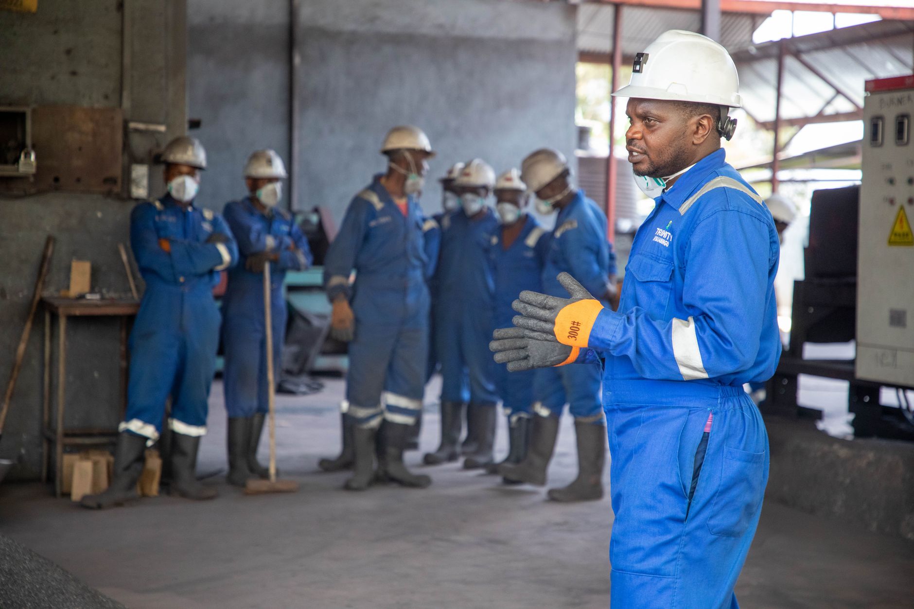 Students in a technical training program working with industrial equipment