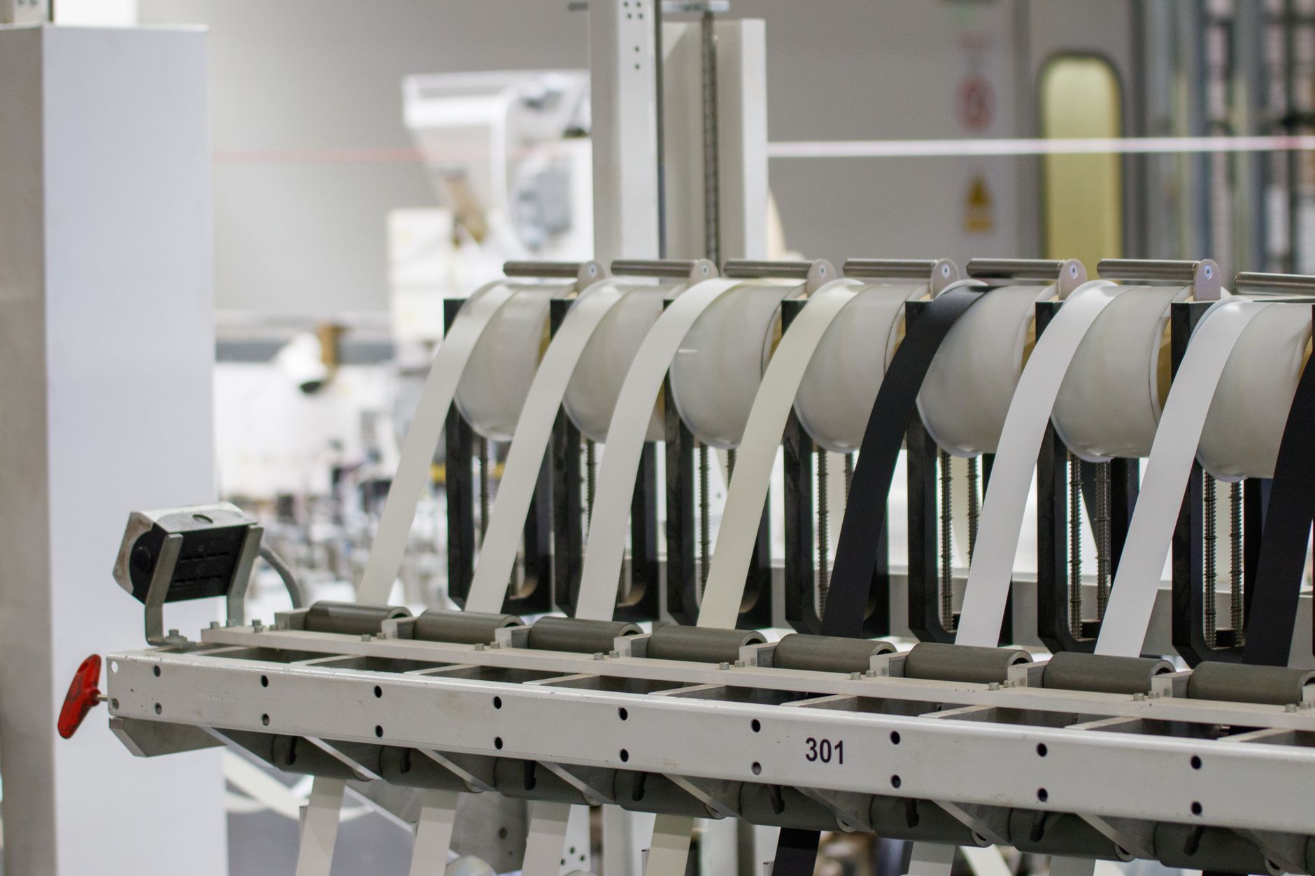 Workers and machinery inside a manufacturing facility on an active production line