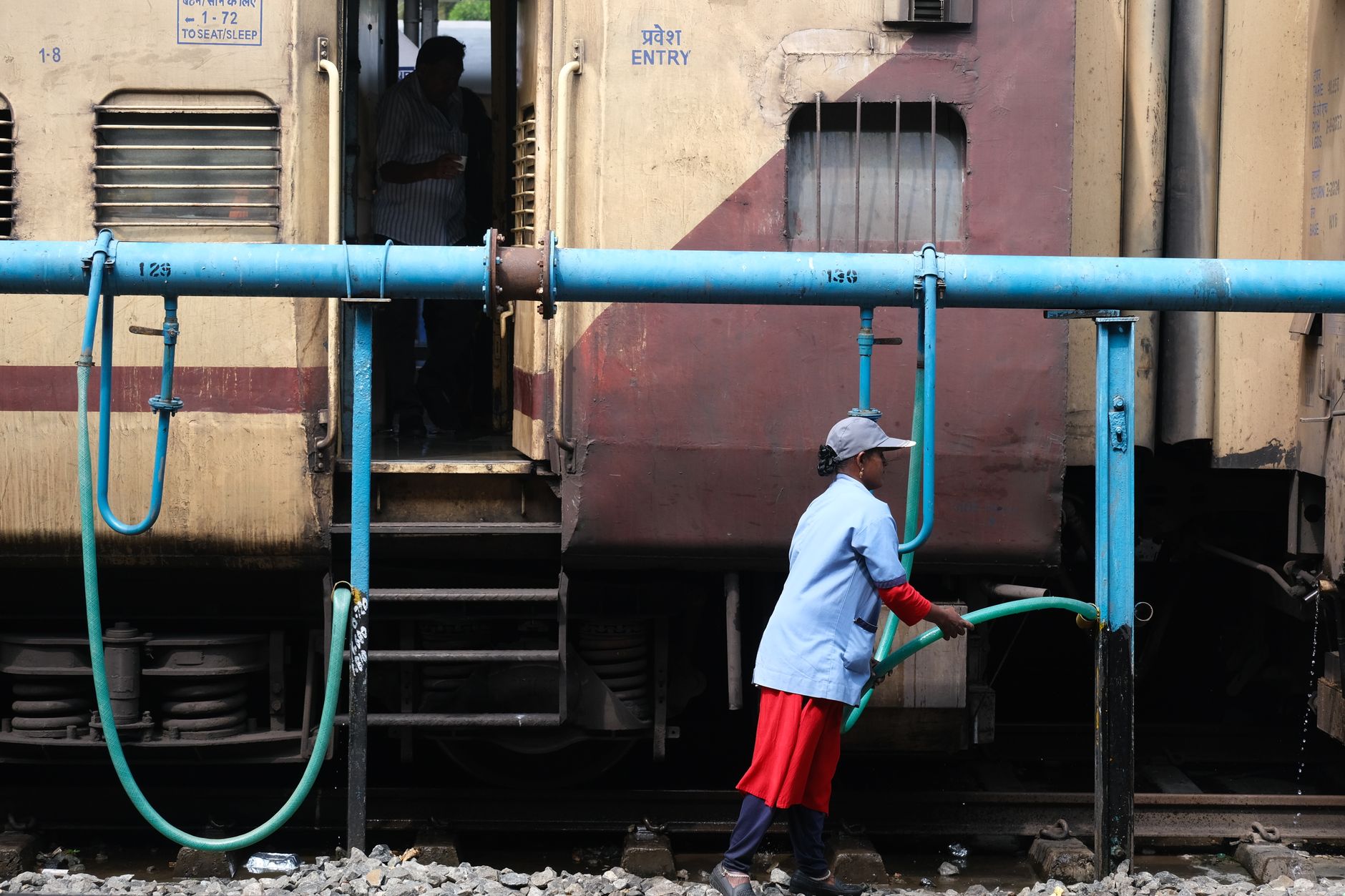 A utility worker inspecting a municipal water main repair site