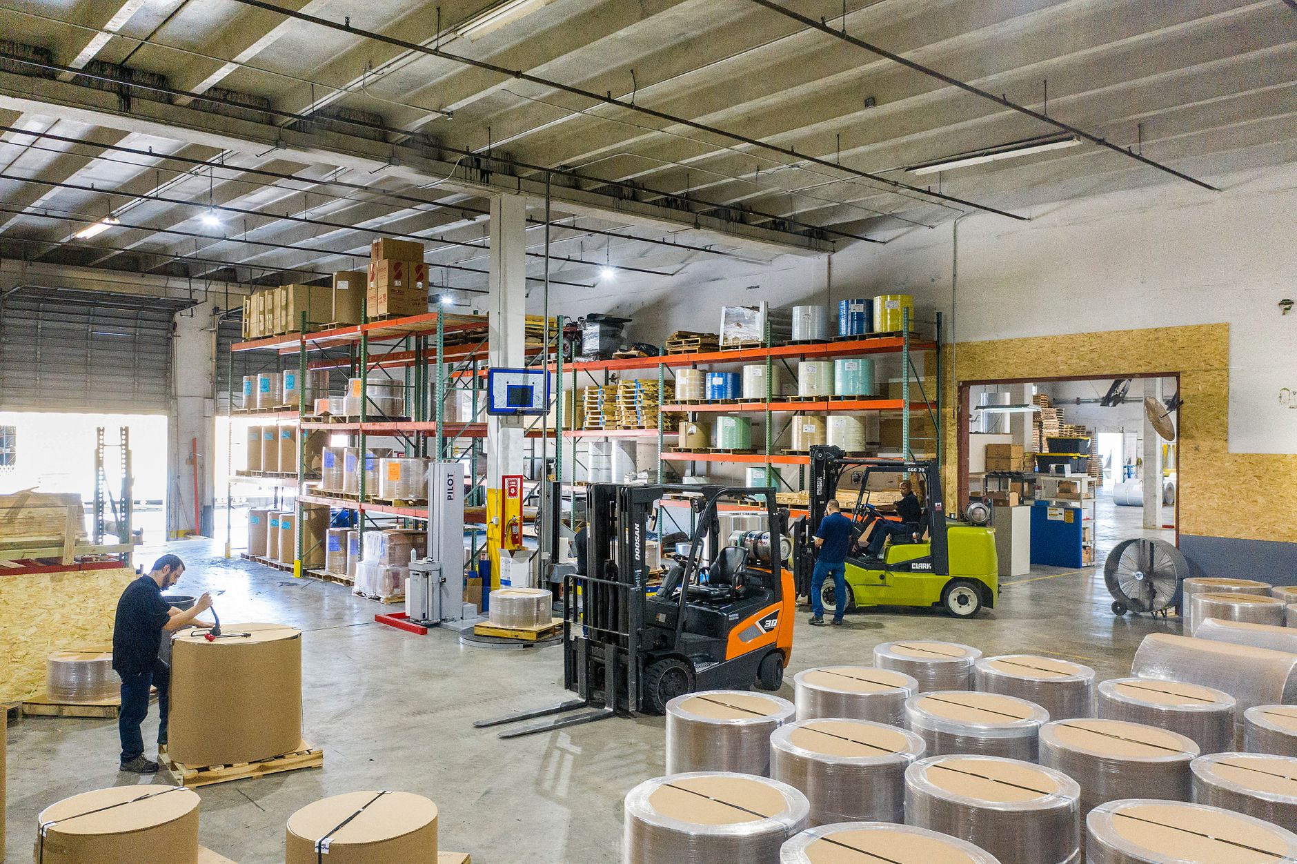 Workers inside a large inland distribution warehouse sorting cargo