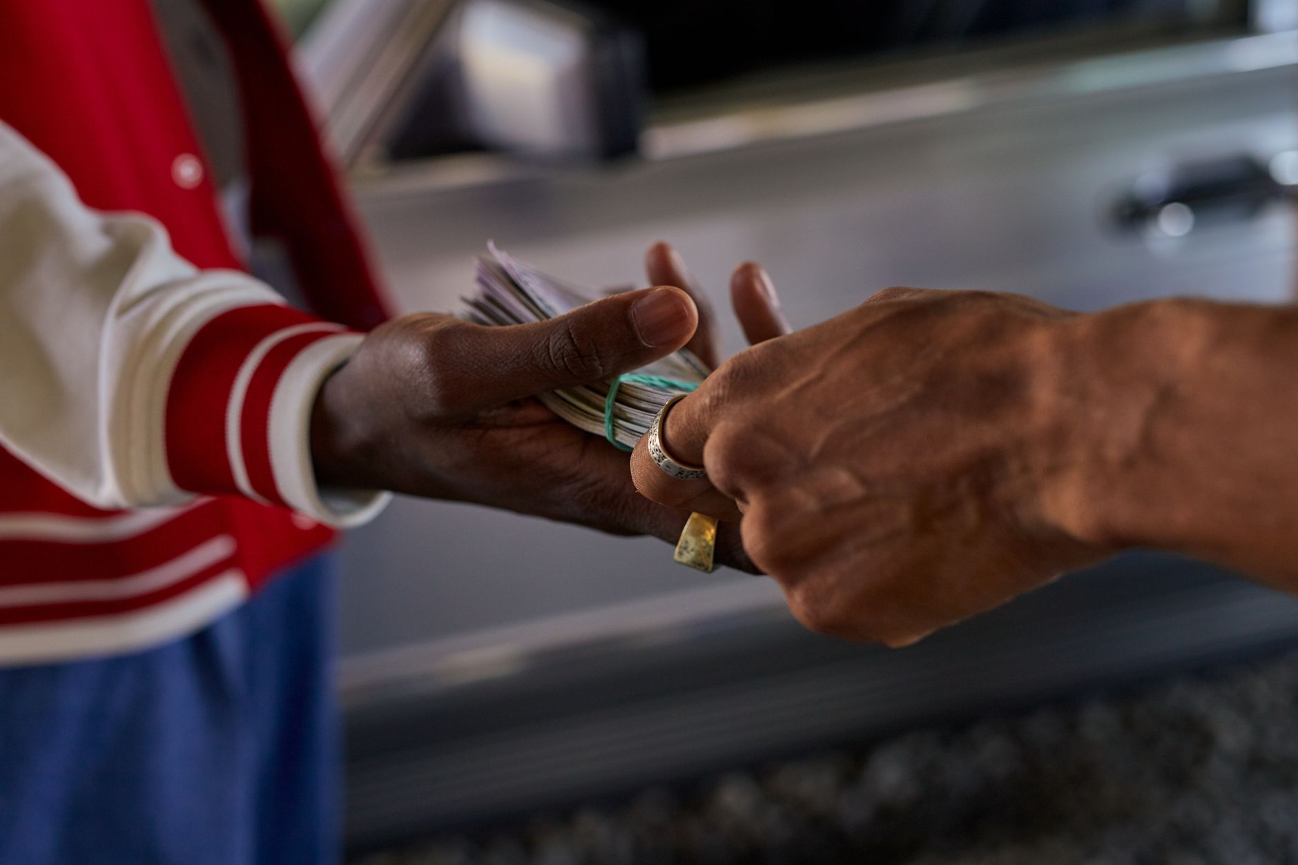 Hands exchanging cash representing short-term lending transactions