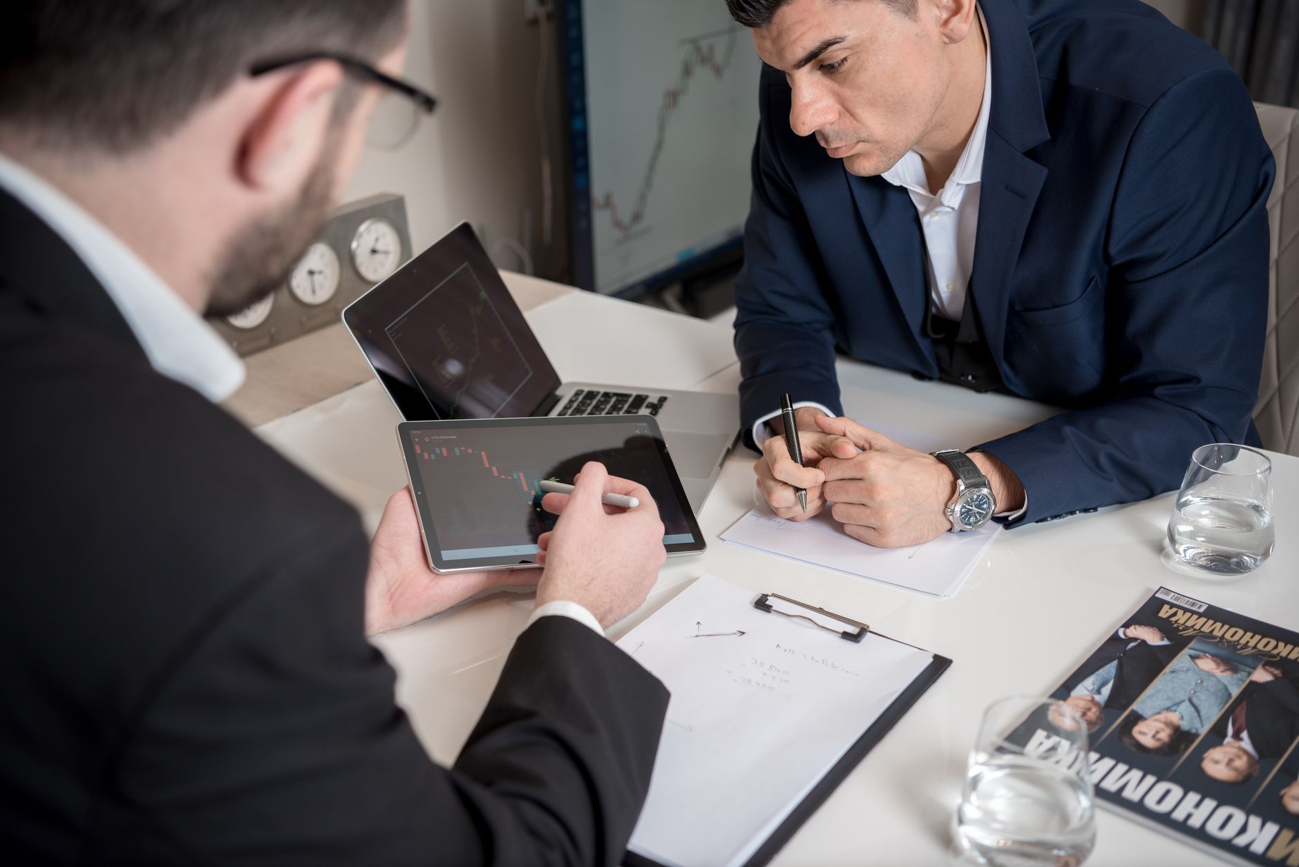 Business professionals reviewing loan or investment terms in a formal meeting