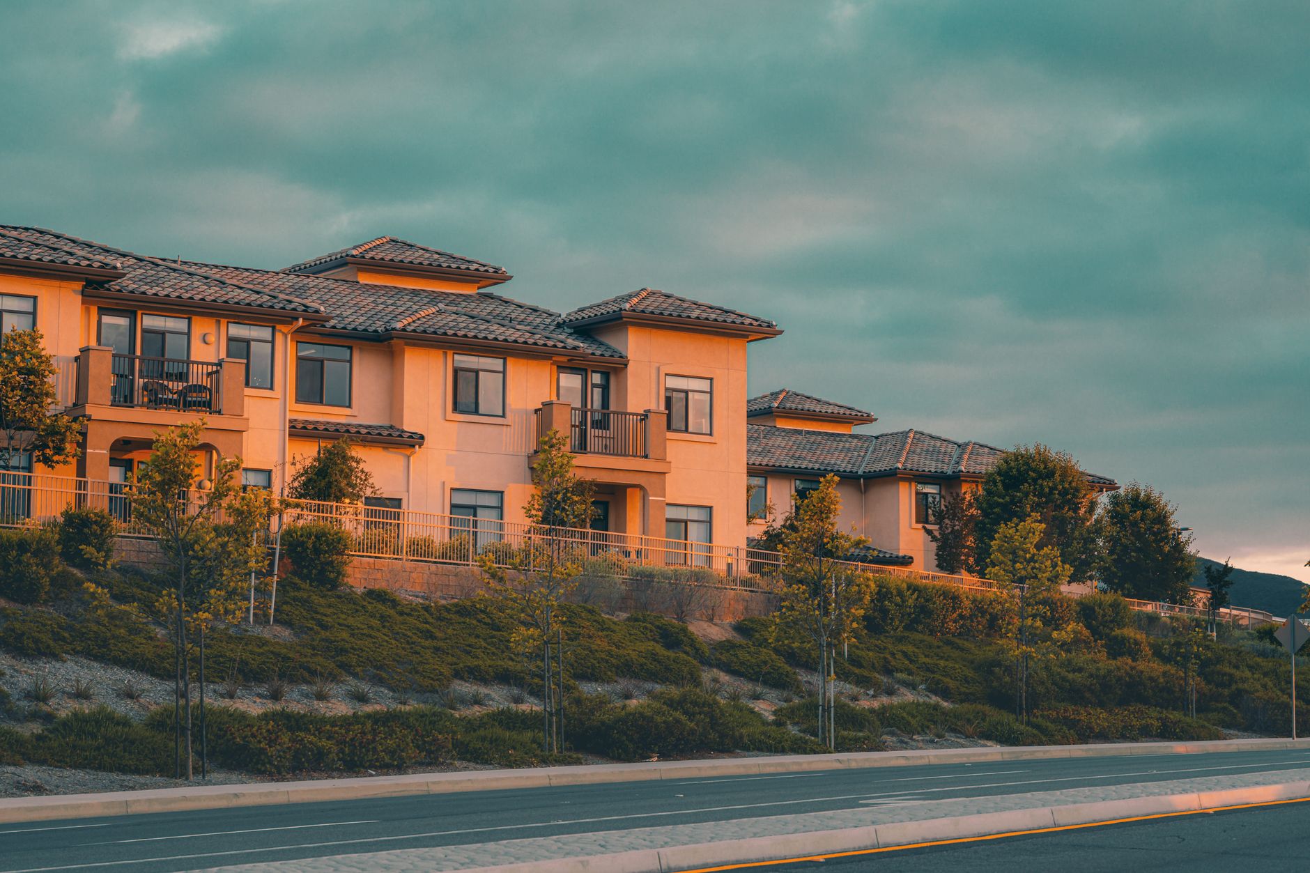 Row of newly built suburban homes lining a quiet residential street