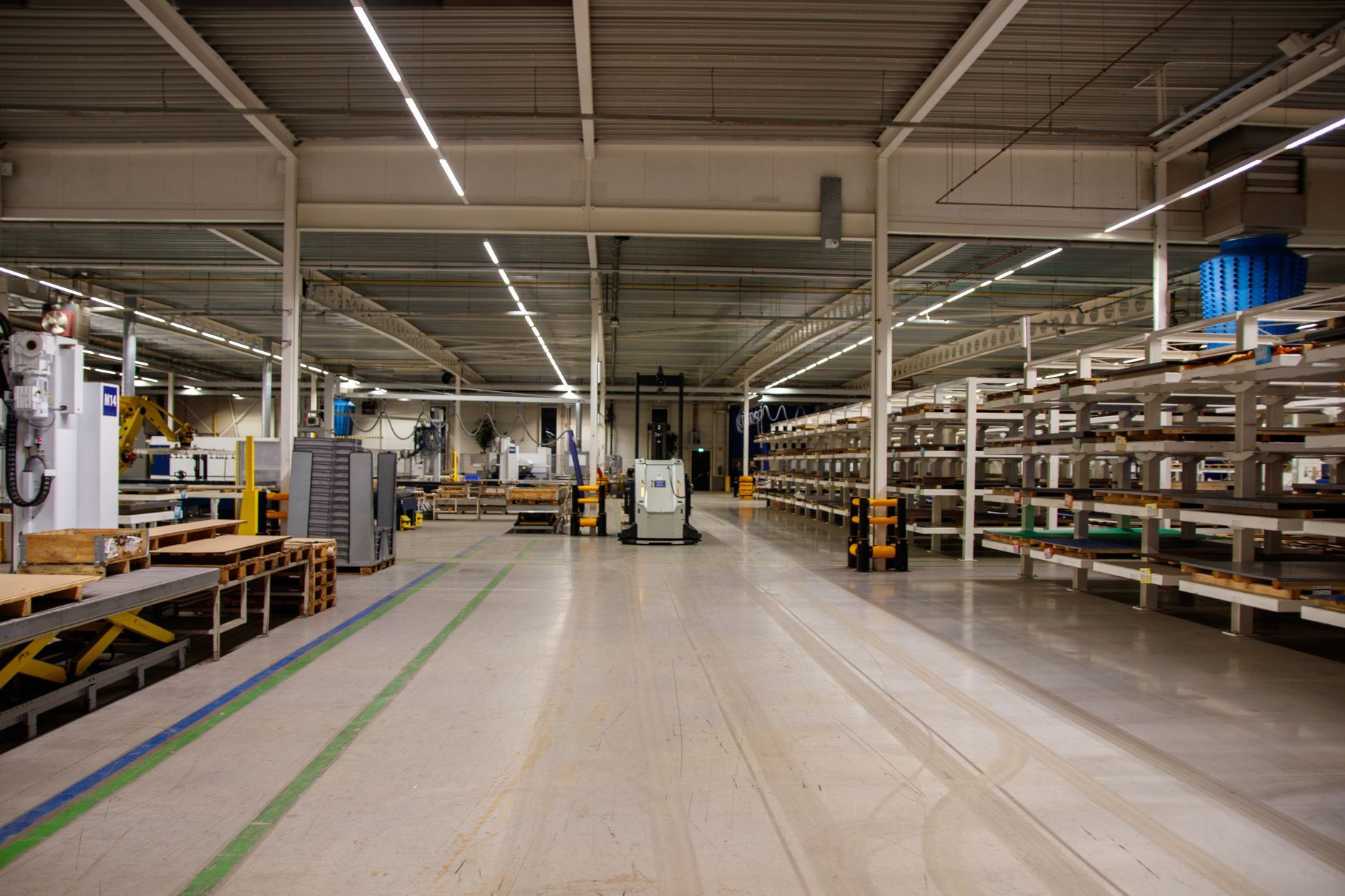 Large industrial equipment and machinery stored in a warehouse facility awaiting installation