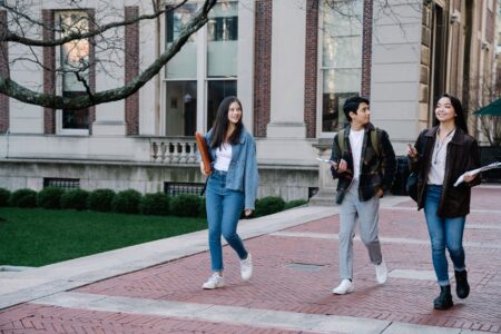 Federal Student Aid Processing Delays Derail Fall Enrollment Plans College students walking across campus before the fall semester begins