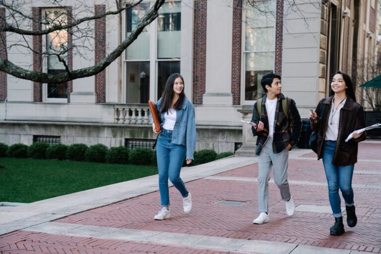 Federal Student Aid Processing Delays Derail Fall Enrollment Plans College students walking across campus before the fall semester begins