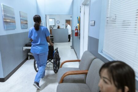 Hospital Staffing Agency Markups Draw State Price Transparency Mandates Empty hospital corridor with nurses station in background