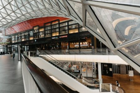 Nearly empty shopping mall corridor with few visible shoppers